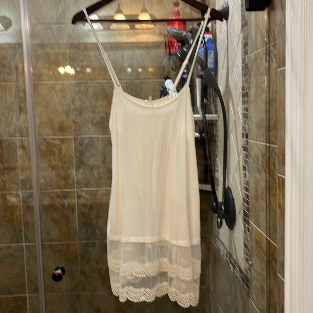 Cream colored slip to wear under shirts with bottom showing